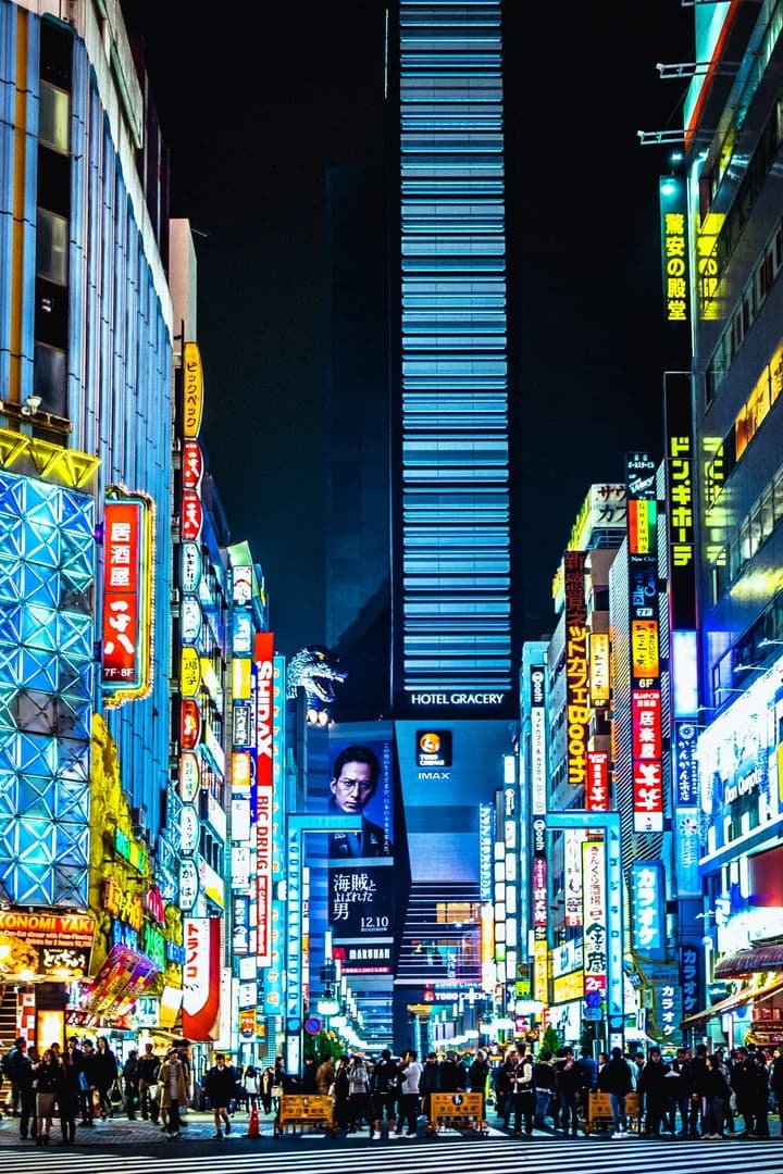 Shinjuku Kabukicho at night, with neon signs, street depth and pedestrians