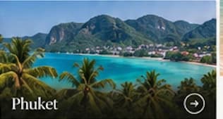 A green island and blue bay framed by palms in Phuket